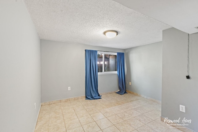 510 W 3rd St, Braidwood, IL 60408 - empty room with tile patterned floors, baseboards, and a textured ceiling