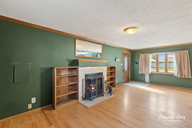 510 W 3rd St, Braidwood, IL 60408 - unfurnished living room featuring a textured ceiling, ornamental molding, wood finished floors, and a tile fireplace