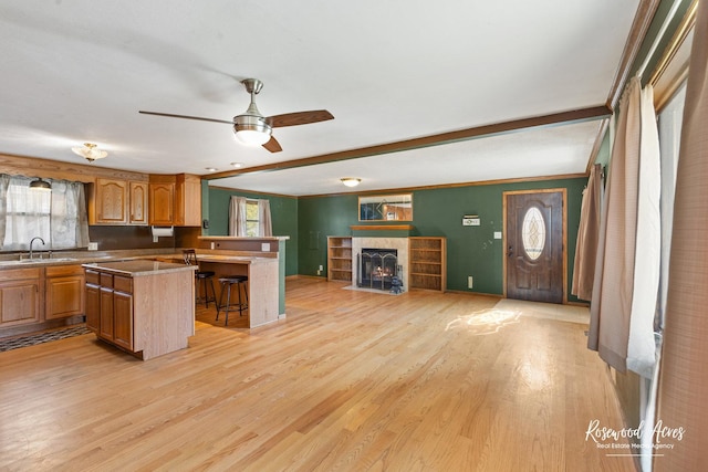 510 W 3rd St, Braidwood, IL 60408 - kitchen featuring ceiling fan, a breakfast bar, a sink, light wood-style floors, and open floor plan