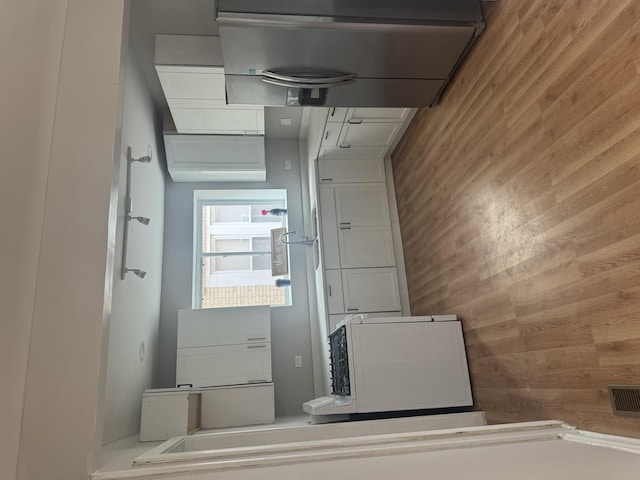 interior space featuring wooden walls and visible vents