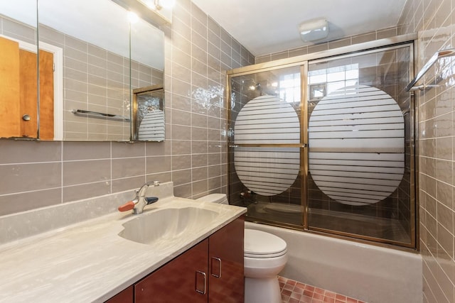 full bath with vanity, decorative backsplash, toilet, tile walls, and enclosed tub / shower combo