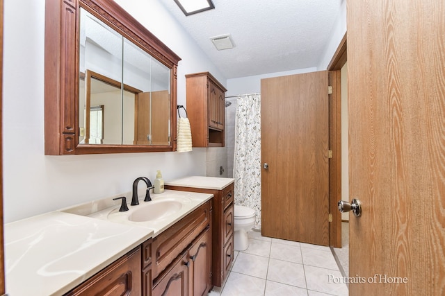 full bathroom featuring toilet, vanity, curtained shower, a textured ceiling, and tile patterned floors