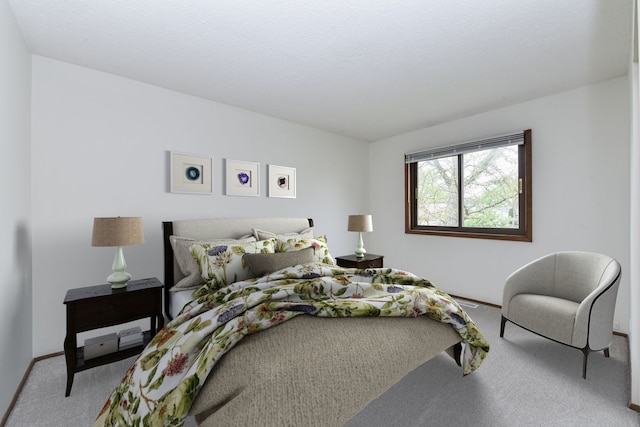bedroom featuring carpet and baseboards