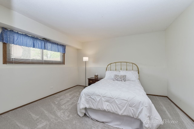 bedroom with carpet flooring and baseboards