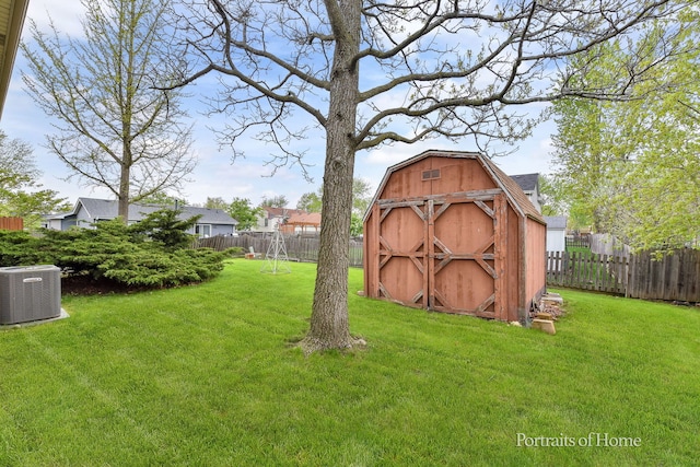 view of shed featuring cooling unit and a fenced backyard