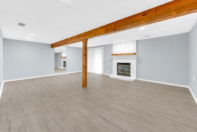 interior space with visible vents, a fireplace, baseboards, recessed lighting, and a paneled ceiling