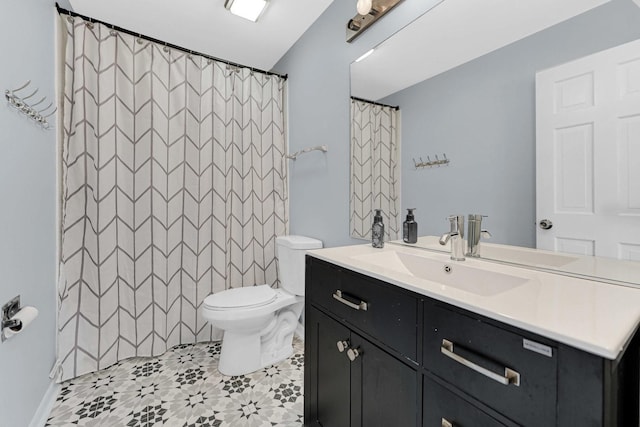 full bath featuring vanity, tile patterned floors, and toilet