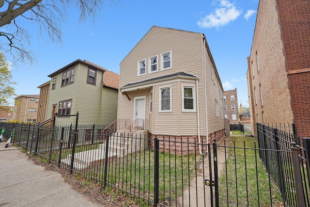 view of front of property featuring a front lawn and a fenced front yard