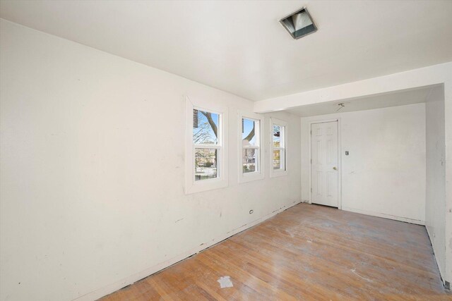 spare room featuring wood finished floors