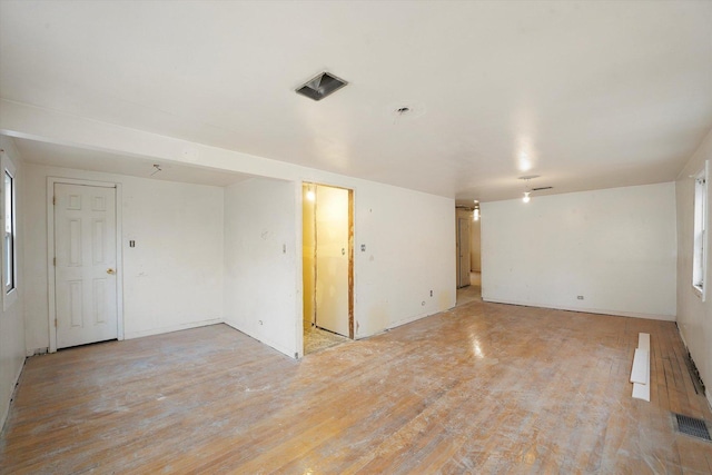 unfurnished room featuring visible vents and light wood-style flooring
