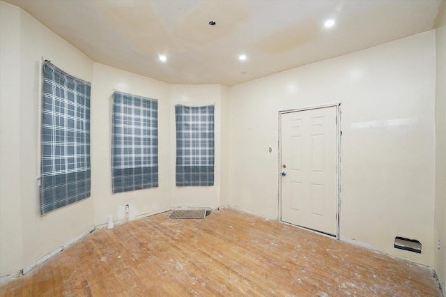 spare room featuring recessed lighting and wood finished floors