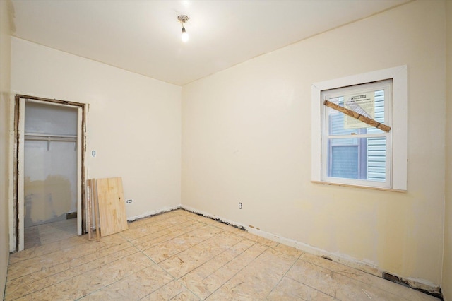 unfurnished bedroom with baseboards and a closet