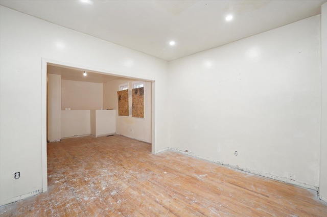 spare room with wood finished floors and recessed lighting