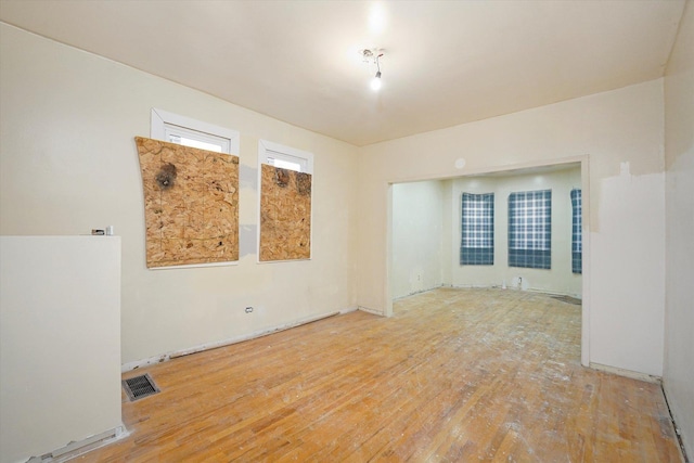 spare room with visible vents and hardwood / wood-style floors