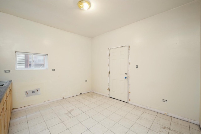 spare room with baseboards
