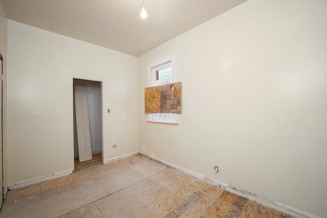 empty room featuring baseboards