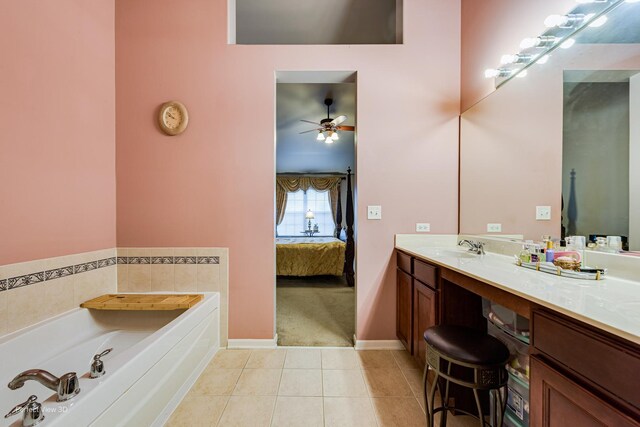 bathroom with connected bathroom, tile patterned floors, a bath, vanity, and baseboards