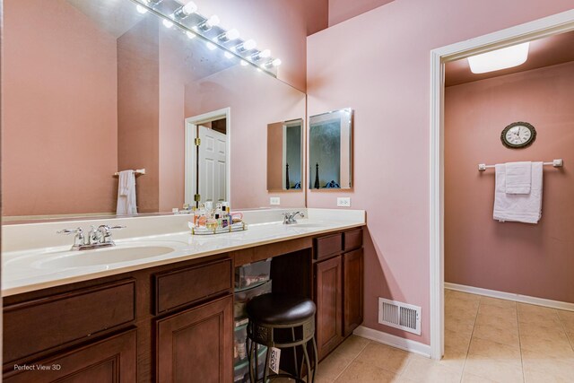 bathroom with double vanity, a sink, tile patterned floors, and visible vents