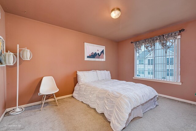 carpeted bedroom featuring baseboards
