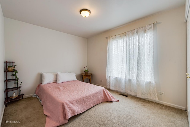 carpeted bedroom with visible vents and baseboards