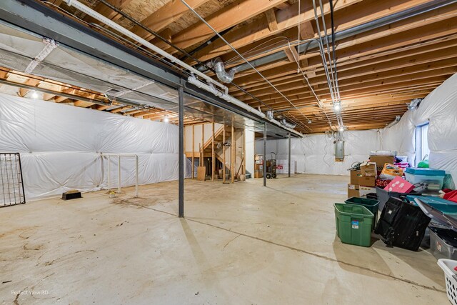 below grade area featuring stairs and electric panel