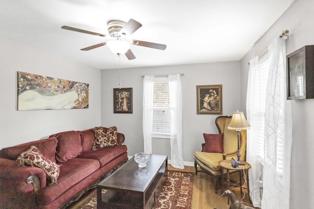 living room with ceiling fan, wood finished floors, and baseboards