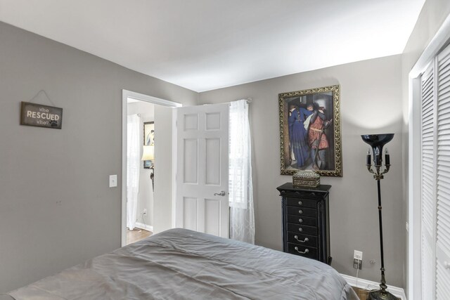 bedroom with wood finished floors and baseboards