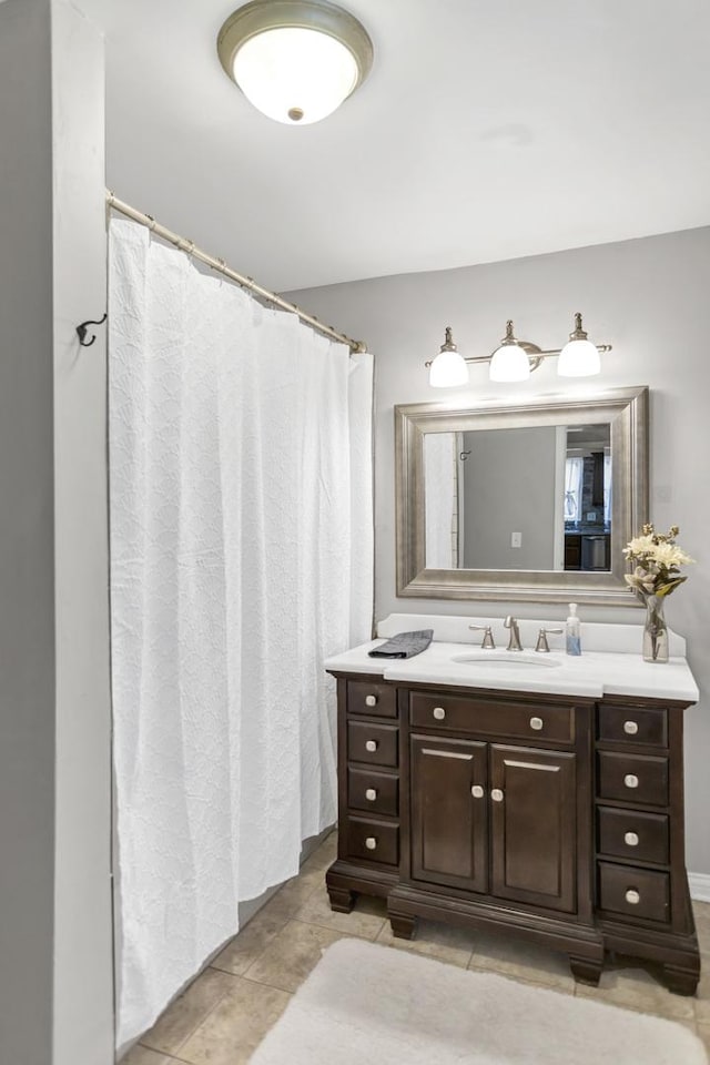bathroom featuring a shower with curtain, tile patterned flooring, and vanity