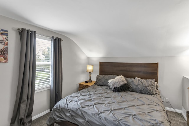 bedroom with carpet, lofted ceiling, and baseboards