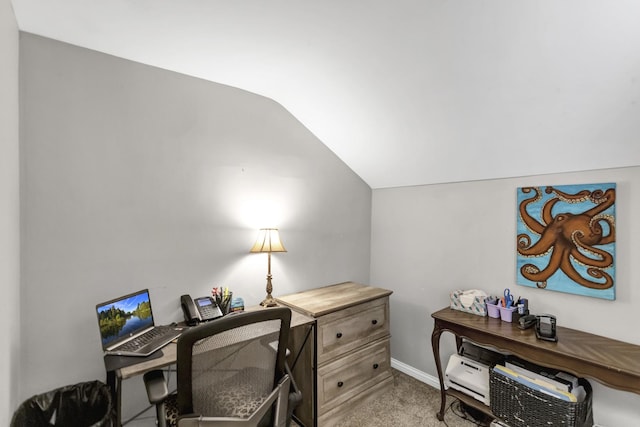 office space with light colored carpet, lofted ceiling, and baseboards