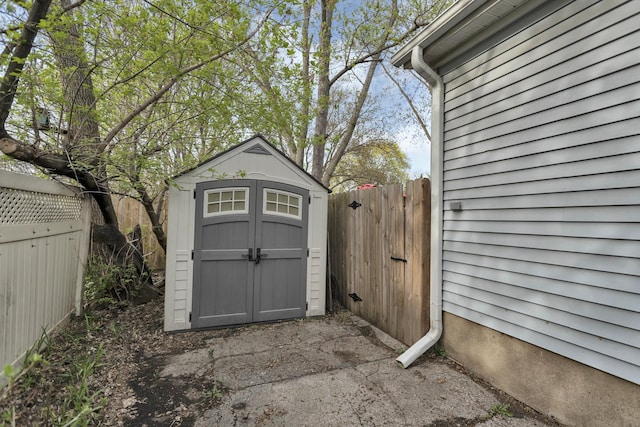 view of shed featuring fence
