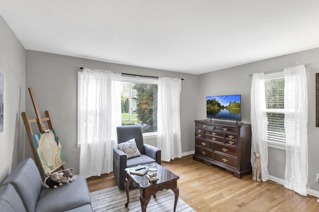 living area with light wood finished floors and baseboards