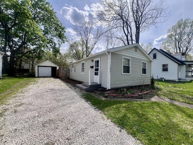 view of front of property featuring a front lawn, an outbuilding, and a garage
