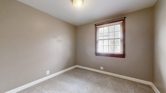 carpeted spare room with baseboards
