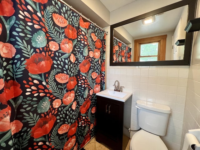bathroom with toilet, tile walls, tile patterned flooring, and vanity