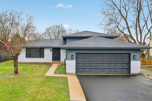 530 Thompson Ave, Winthrop Harbor, IL 60096 - view of front facade with brick siding, aphalt driveway, roof with shingles, a front yard, and an attached garage