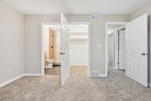 530 Thompson Ave, Winthrop Harbor, IL 60096 - unfurnished bedroom featuring visible vents, a spacious closet, and carpet flooring