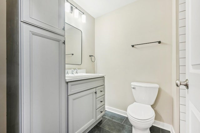 530 Thompson Ave, Winthrop Harbor, IL 60096 - bathroom with vanity, toilet, tile patterned flooring, and baseboards