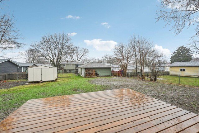 530 Thompson Ave, Winthrop Harbor, IL 60096 - wooden terrace with a fenced backyard, a shed, a yard, and an outdoor structure