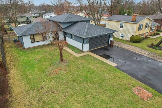 530 Thompson Ave, Winthrop Harbor, IL 60096 - exterior space with a chimney, a shingled roof, a garage, a residential view, and driveway