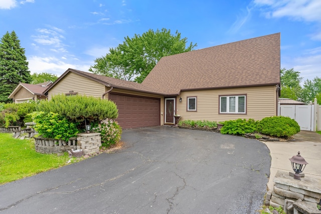 17475 Eastgate Dr, Country Club Hills, IL 60478 - view of front of property with a garage, asphalt driveway, a shingled roof, and a gate