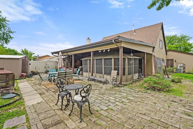 17475 Eastgate Dr, Country Club Hills, IL 60478 - back of property featuring a patio, a sunroom, a chimney, cooling unit, and roof with shingles