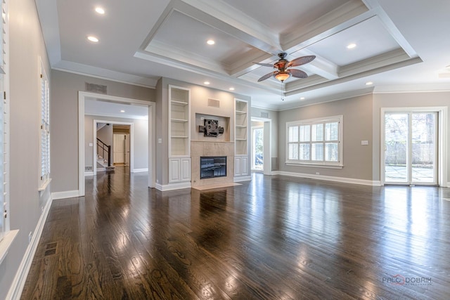 unfurnished living room featuring dark wood-style floors, visible vents, a ceiling fan, and stairway