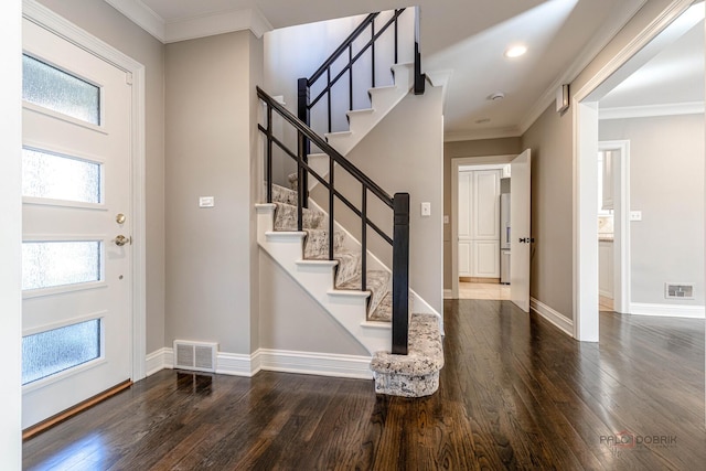 foyer with stairs, visible vents, hardwood / wood-style floors, and baseboards