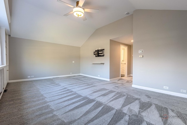 unfurnished living room with baseboards, ceiling fan, carpet floors, and vaulted ceiling