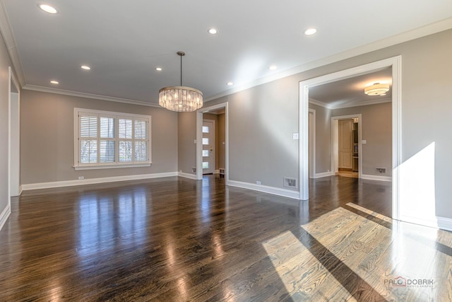unfurnished room with ornamental molding, dark wood-style flooring, a chandelier, and baseboards