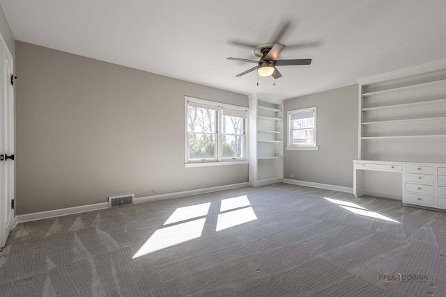 unfurnished bedroom with baseboards, visible vents, a ceiling fan, and carpet flooring