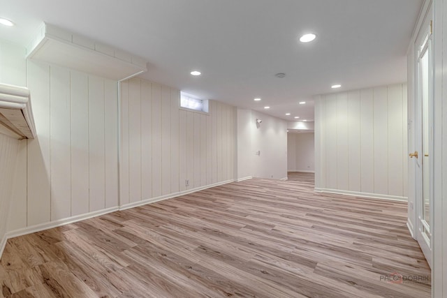 basement featuring recessed lighting, baseboards, and light wood-style floors