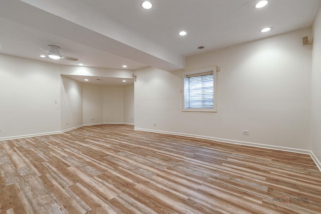 empty room featuring baseboards and recessed lighting