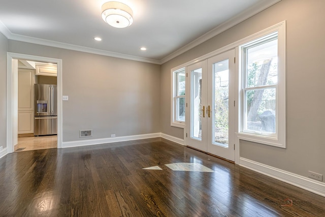 empty room with visible vents, wood finished floors, french doors, and baseboards